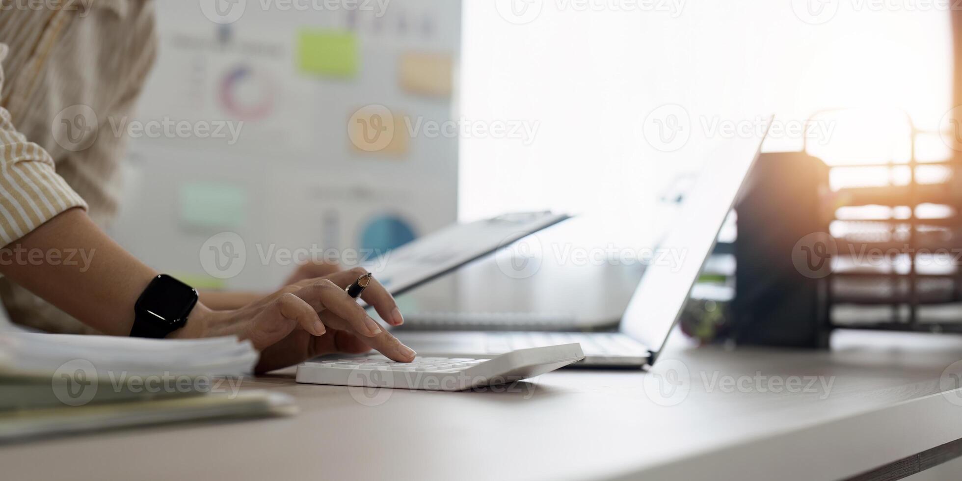 Accountant, bookkeeper using calculator to calculate financial report . account and allocating company budget. photo