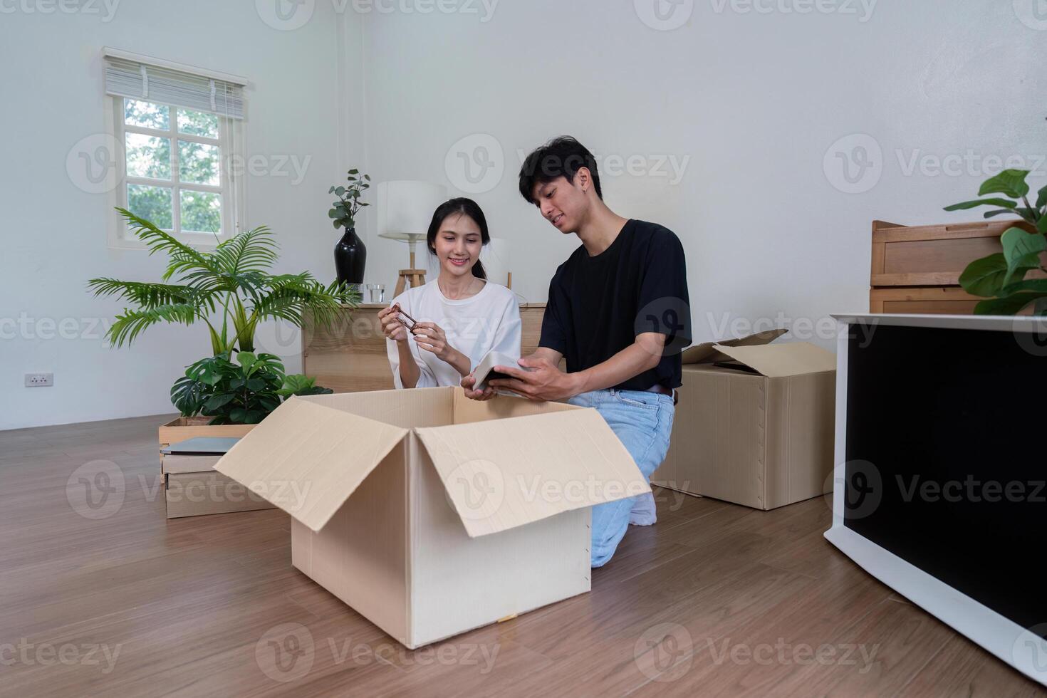 Happy Couple Unpacking Boxes in Their New Home - Moving Day, New Beginnings, and Fresh Start photo