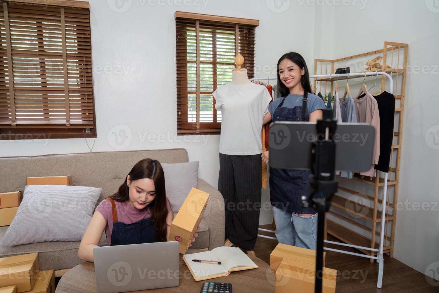 Lesbian Couple Running Online Live Selling Business from Home, Engaging Customers with Fashion and Clothing Products photo