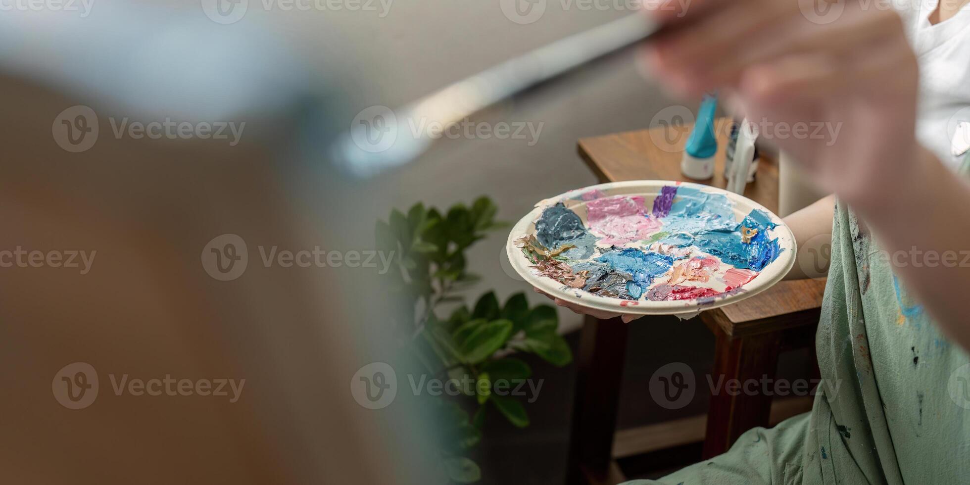Artist Painting in Workshop with Colorful Palette and Brush, Creative Studio Environment, Artistic Process, Close Up of Hand and Paint, Inspiring Art Scene, Professional Painter at Work photo