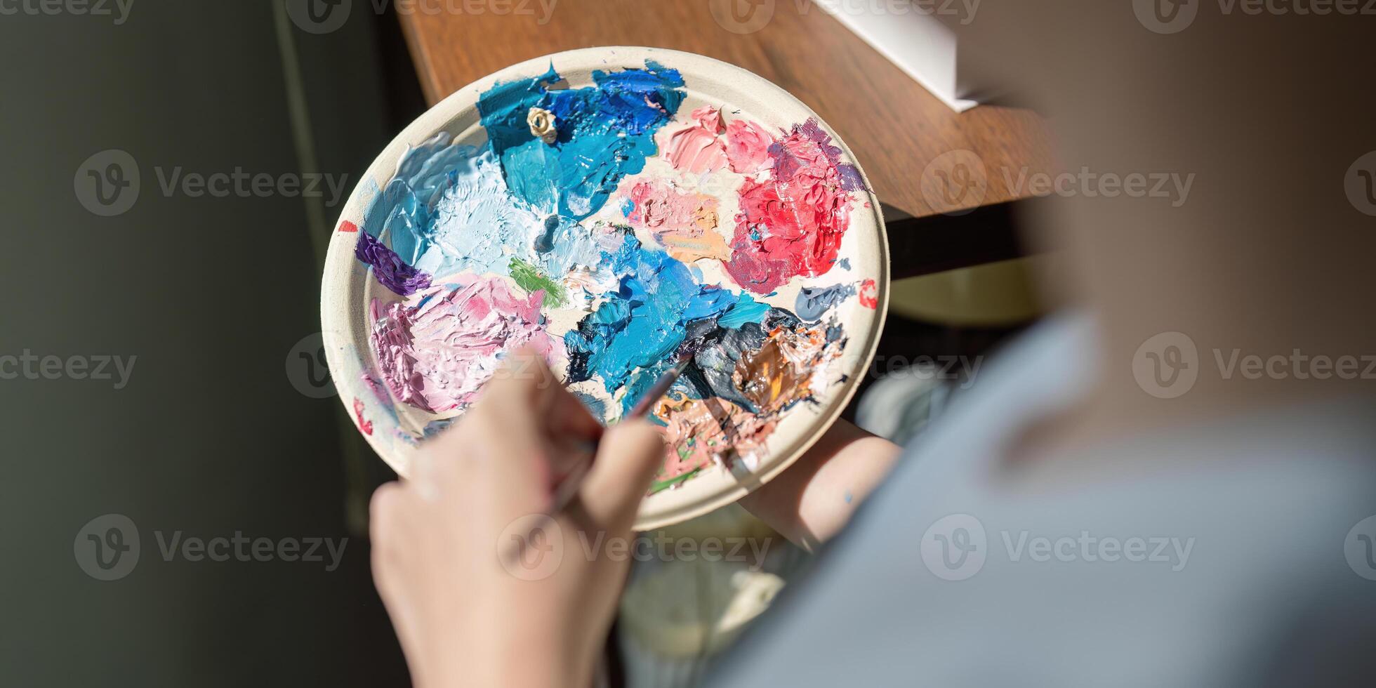 Artist in Workshop Creating Colorful Painting on Palette, Close Up of Hands Mixing Paints, Creative Process in Art Studio, Professional Painter at Work, Artistic Expression, Vibrant Colors, Fine Arts photo