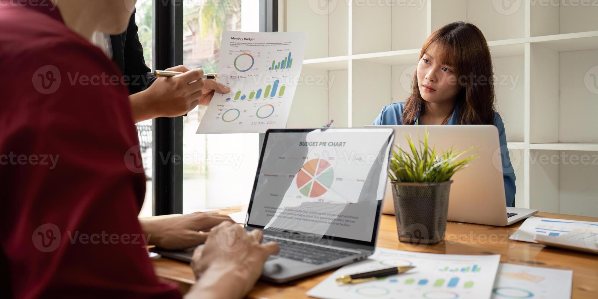 Business Team Analysis Financial Data and Discuss Strategy in Modern Office Setting with Laptops and Charts photo