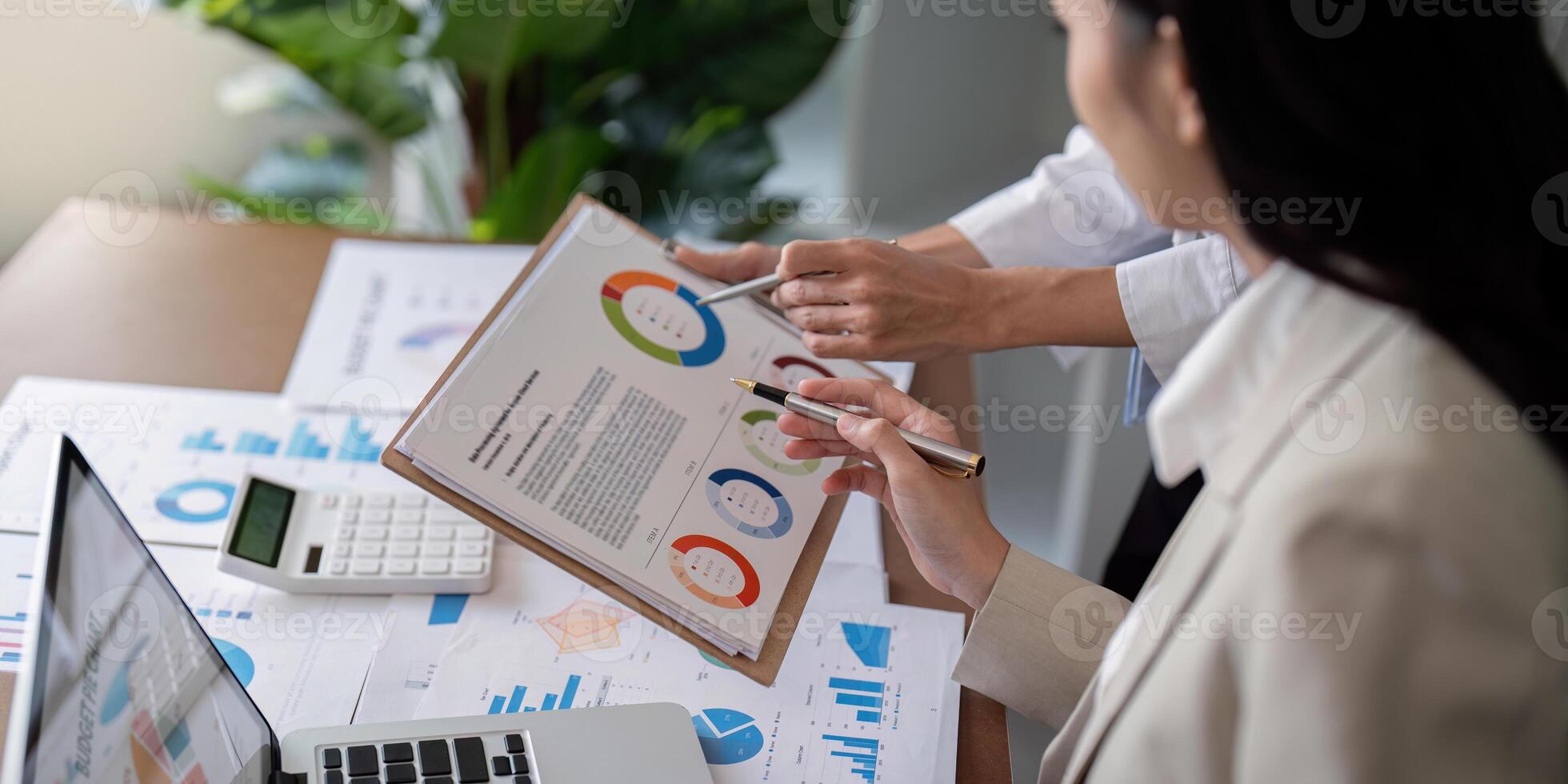 Business Teamwork Planning and Analysis Discussion in Modern Office Setting with Charts and Graphs photo