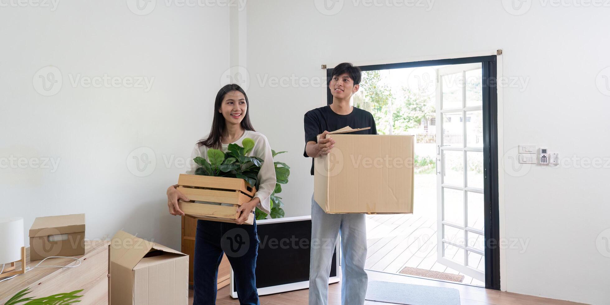 Happy Couple Moving into New House with Boxes and Plants, Starting a New Chapter in Their Lives photo