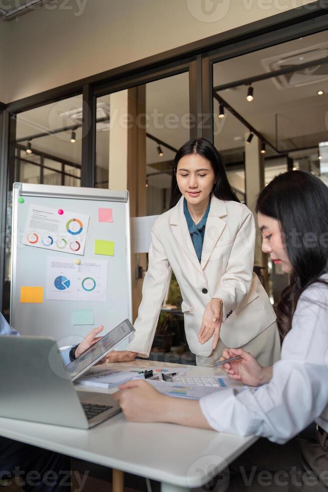 Business Team Collaboration on Data Analysis in Modern Office Setting with Charts and Laptops photo