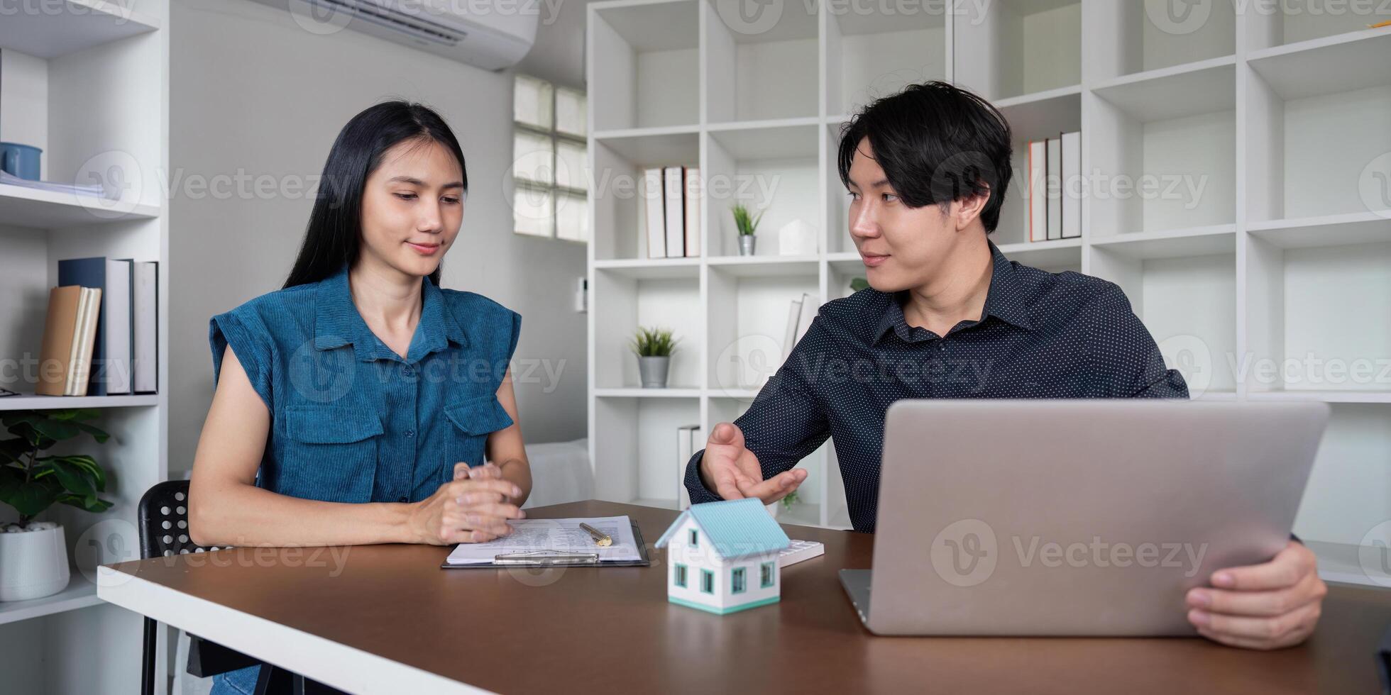 Real Estate Agent Discussing Buy Sell Contract with Client in Modern Office Setting photo