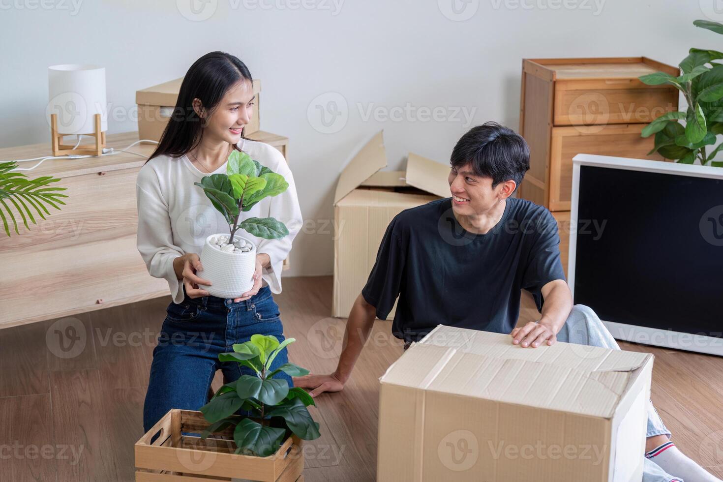 Happy Couple Unpacking Boxes and Moving into New Home, Starting Fresh in Modern Living Space photo