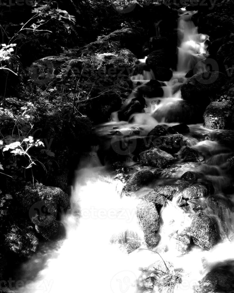 Waterfall and the mountain river background. Waterscape natural environment black and white photo background