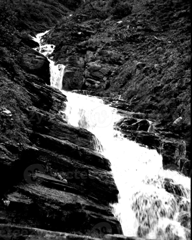 Waterfall and the mountain river background. Waterscape natural environment black and white photo background