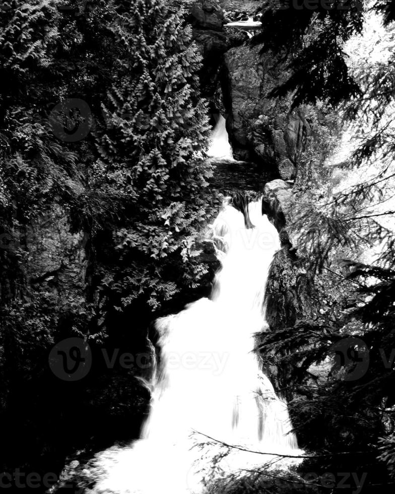 Waterfall and the mountain river background. Waterscape natural environment black and white photo background
