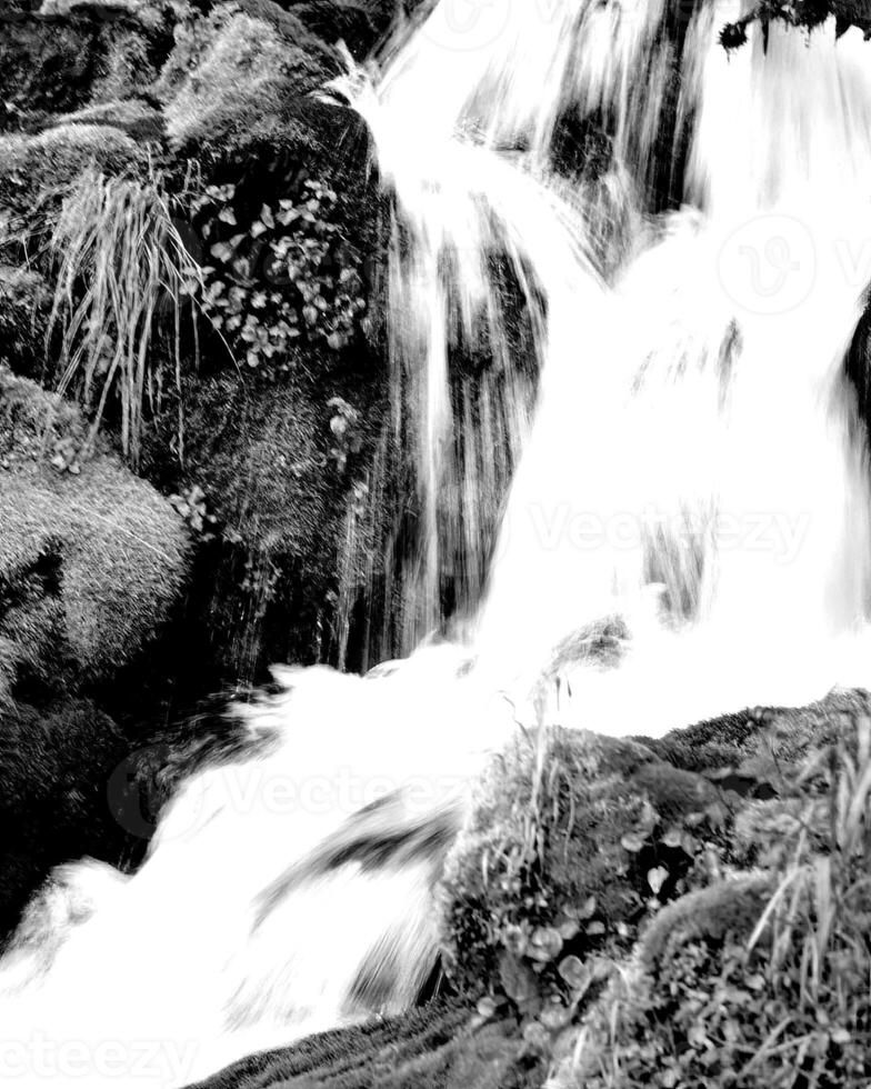 Waterfall and the mountain river background. Waterscape natural environment black and white photo background