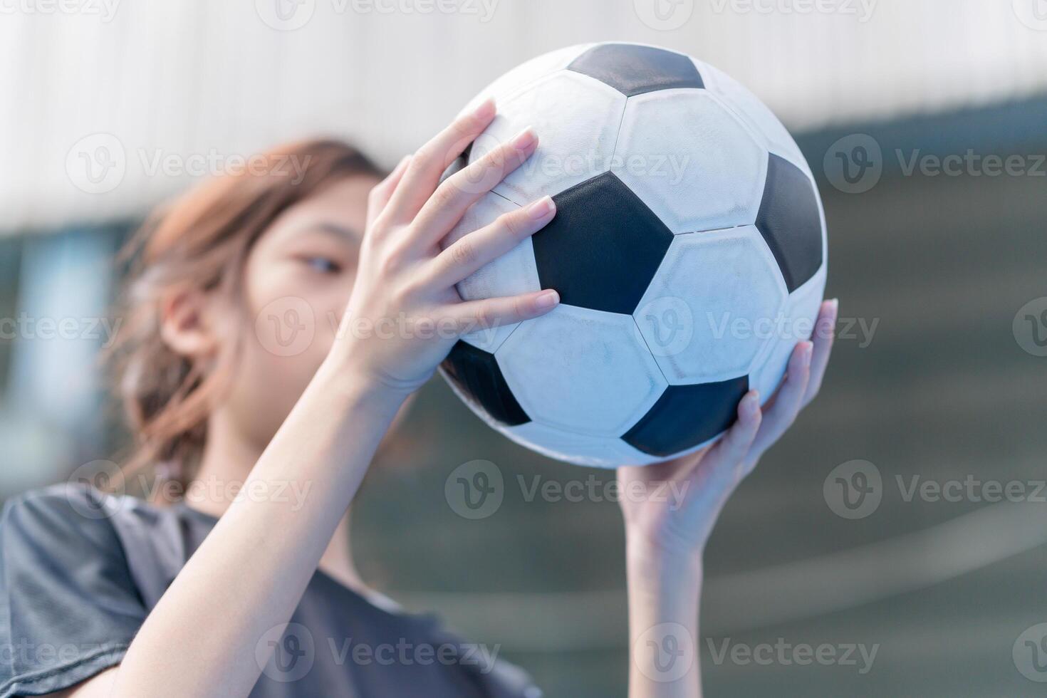 Asian child girl with soccer ball, Kid girl playing football photo