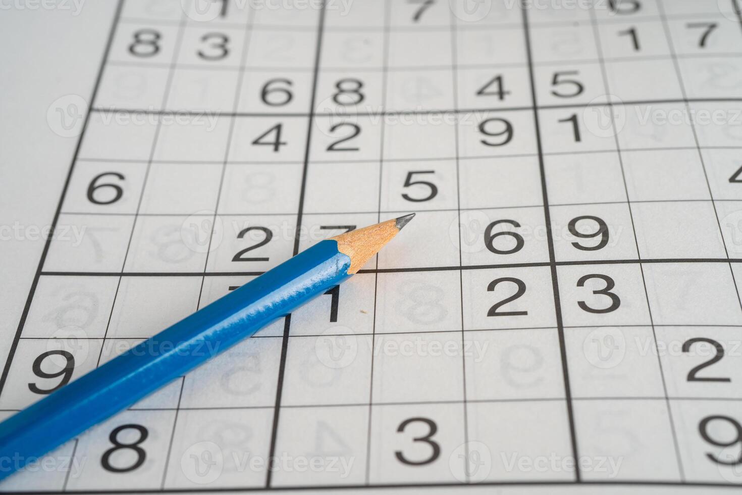 Sudoku puzzle game playing to challenge brain. photo