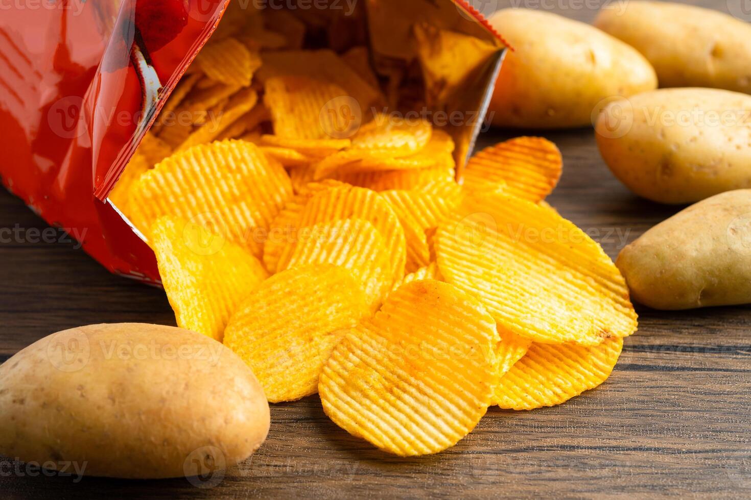 Potato chips, delicious BBQ seasoning spicy for crips, thin slice deep fried snack fast food in open bag. photo