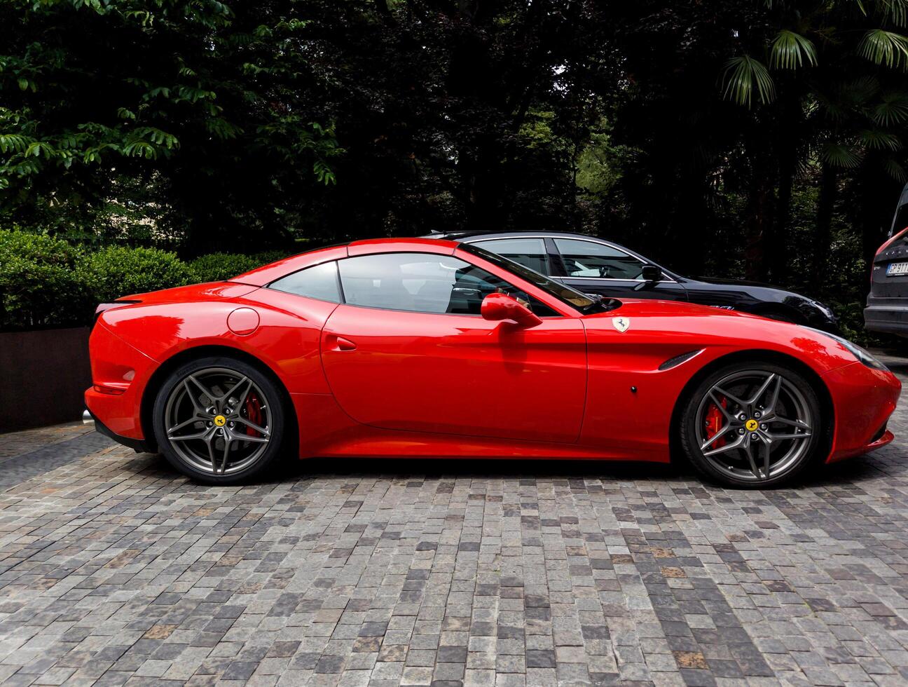 Milan, Italy, June 18, 2024 - Luxury Ferrari parked in the street photo