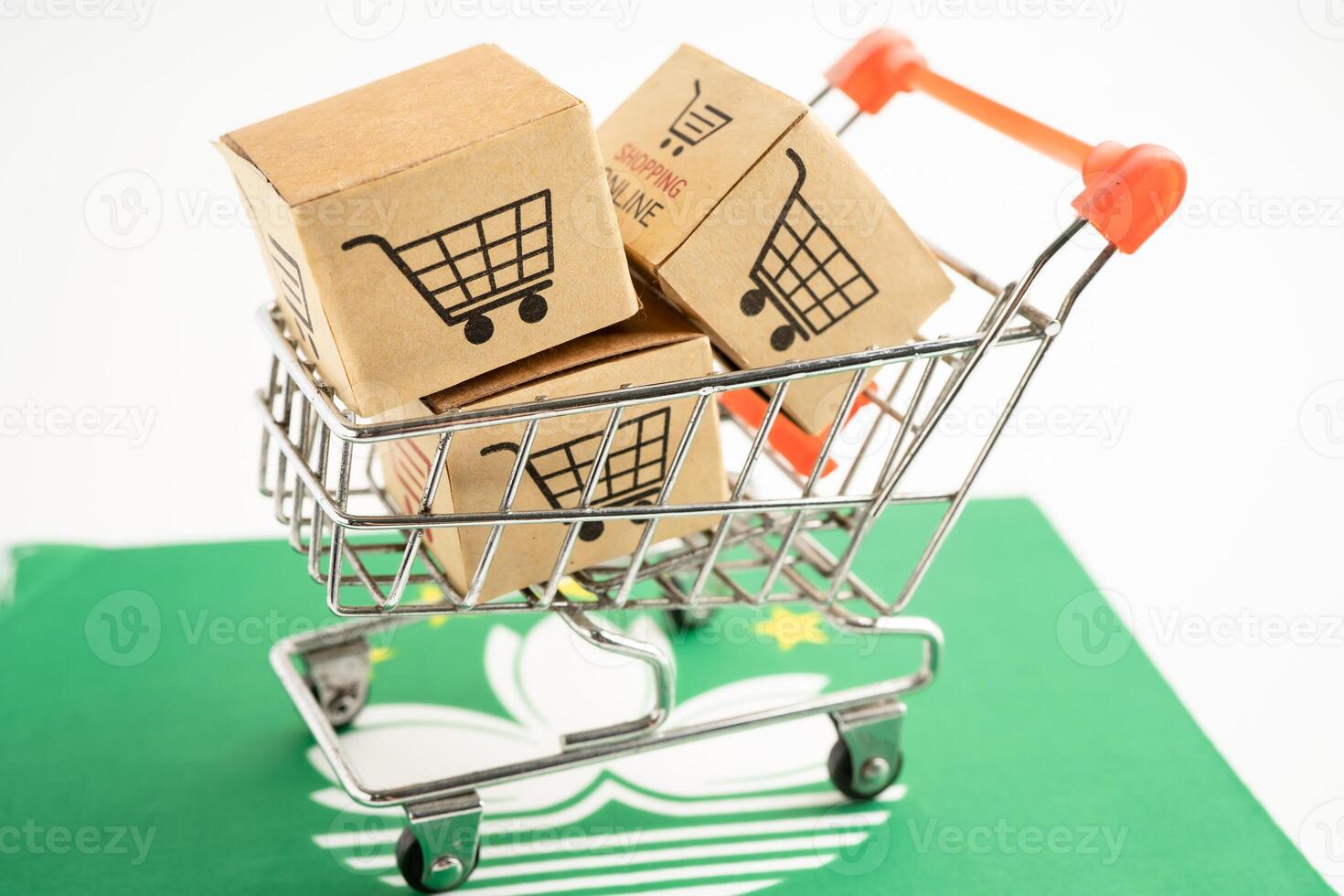 Box with shopping online cart logo and Macau flag, Import Export commerce finance delivery trade. photo