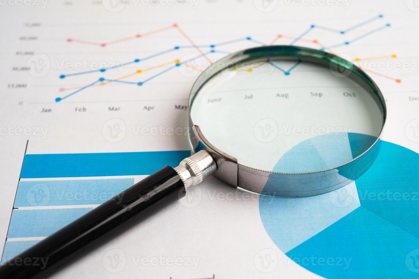 Magnifying glass on spreadsheet and graph paper. Financial development, Banking Account, Statistic, Investment Analytic research data economy, Business. photo