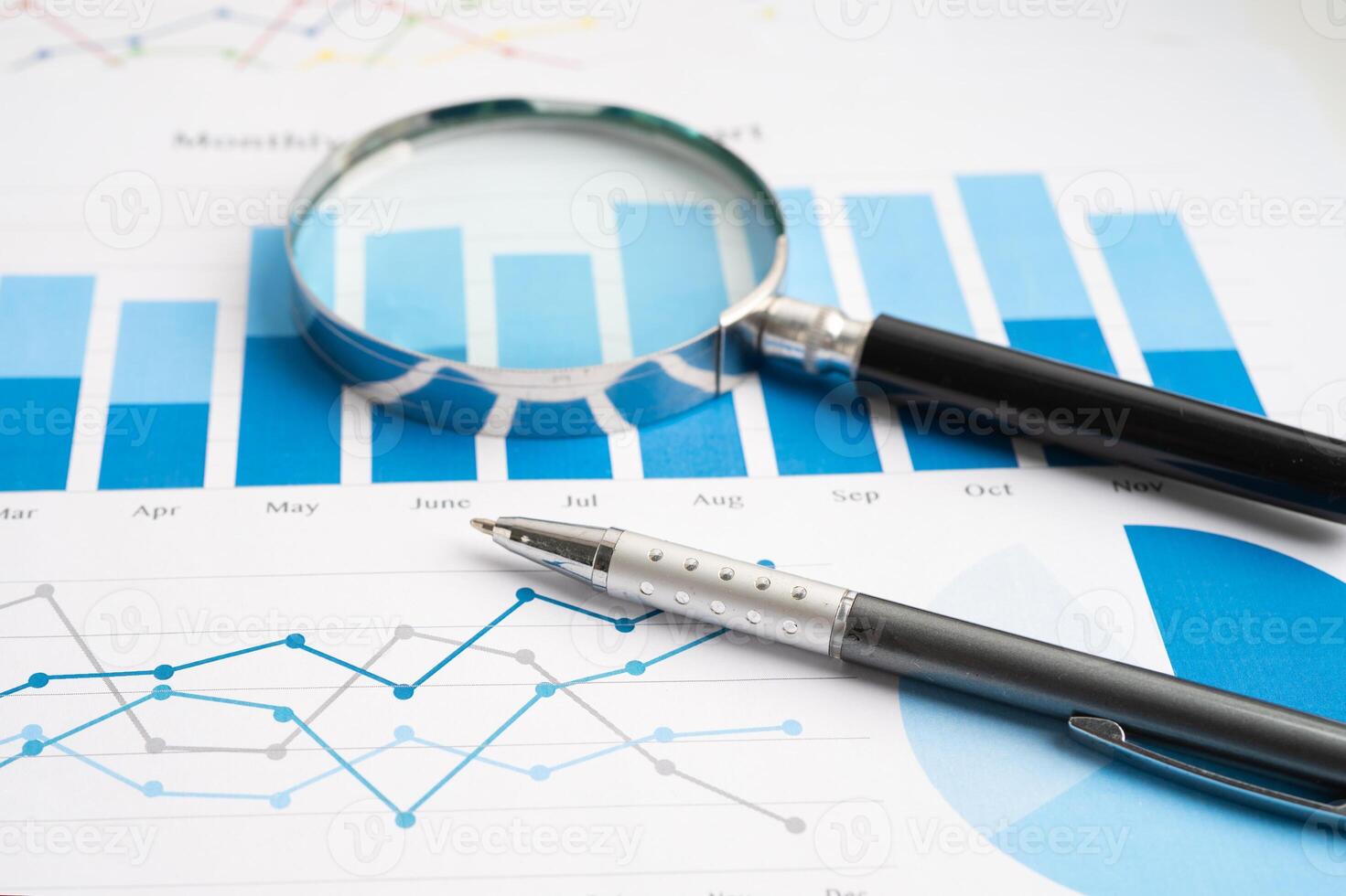 Magnifying glass on spreadsheet and graph paper. Financial development, Banking Account, Statistic, Investment Analytic research data economy, Business. photo