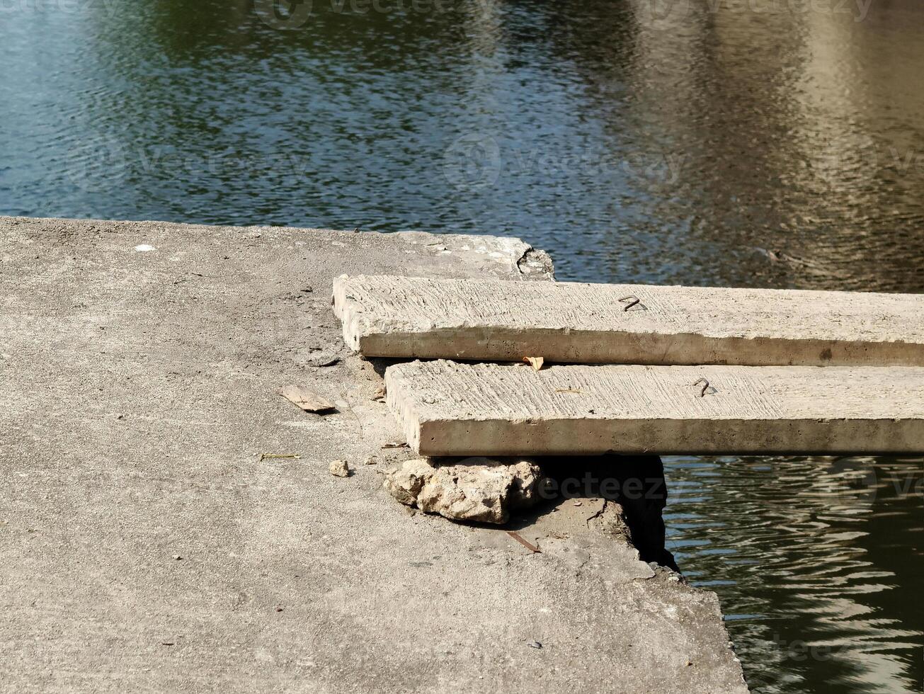 concrete bridge with a broken river on the background of the city. photo