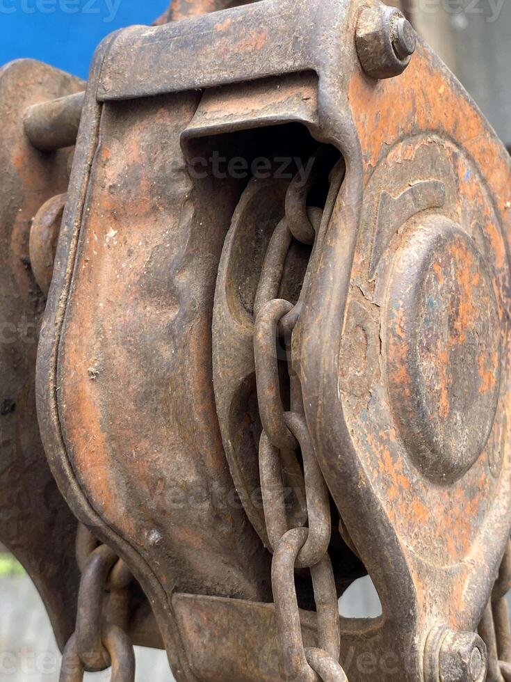 old rusty metal reel and chain photo