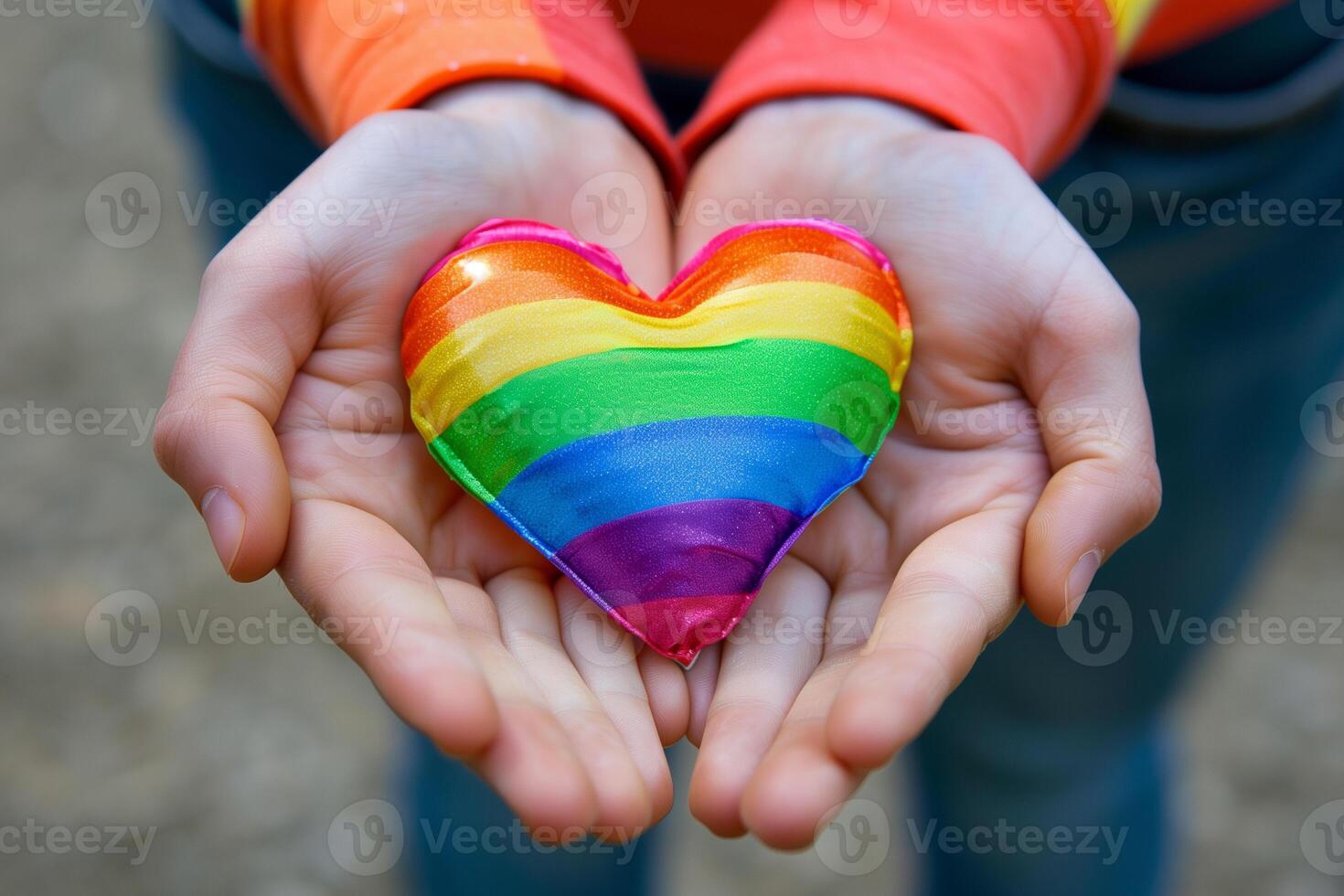 Rainbow heart in the colors of the lgbt flag in female hands, pride month photo