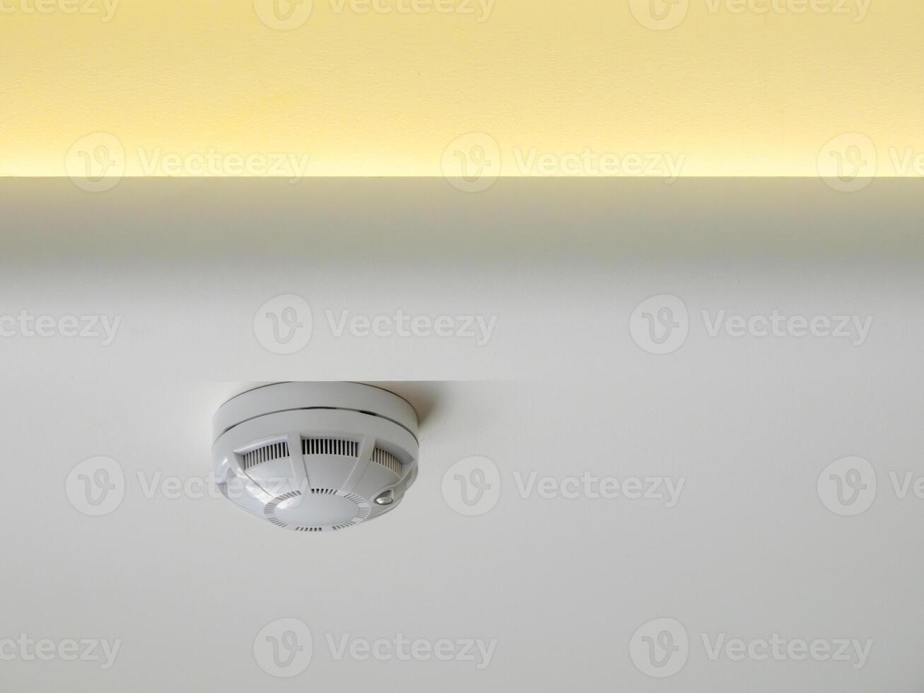 fire alarm sensor on the ceiling with LED lighting photo