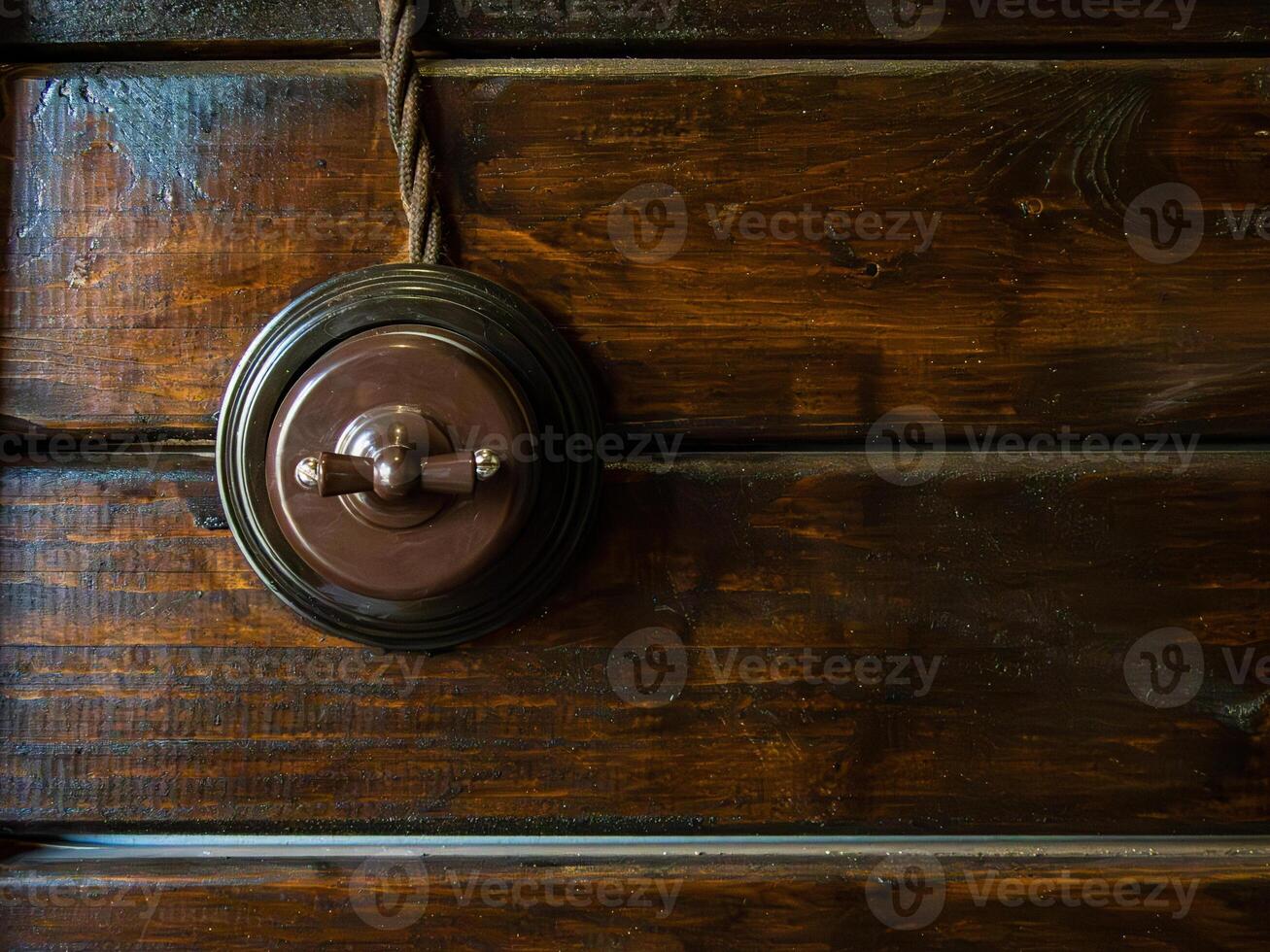 retro switch in a loft interior on a wall made of wooden boards photo