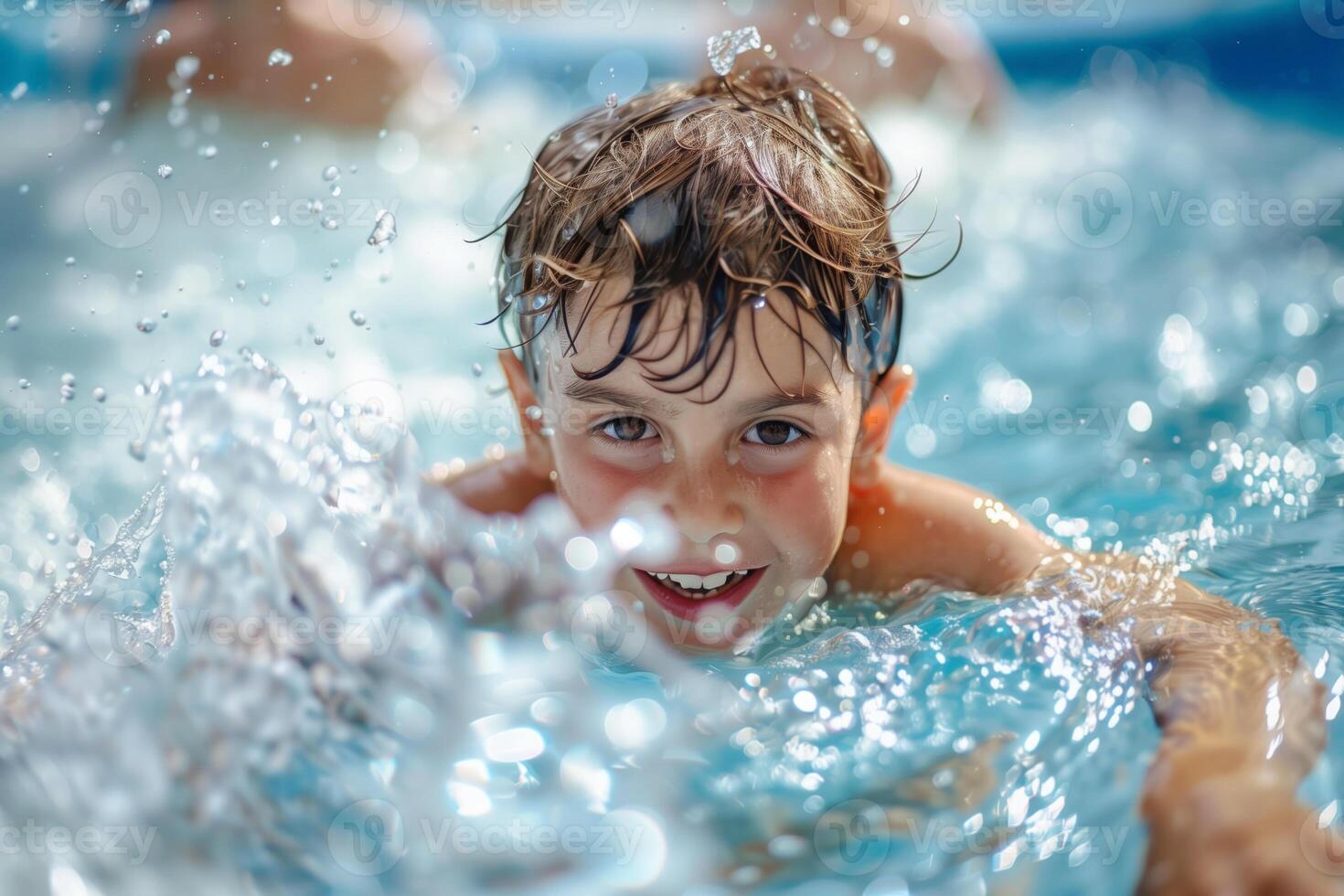 Happy little boy having fun in swimming pool on a hot summer day photo