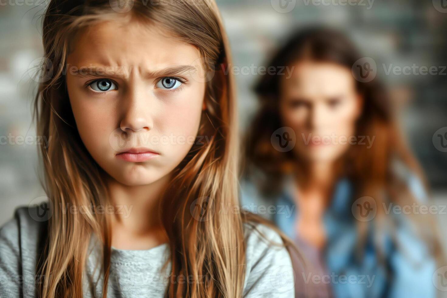 Portrait of offended little girl sitting with her mother on blurred background, concept of difficult relationships between children and parents photo