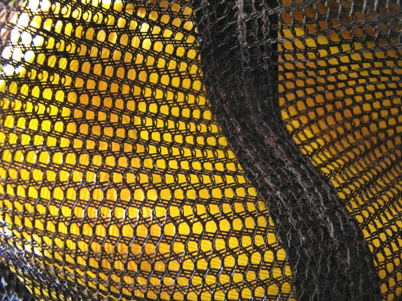 a close up of a yellow and black mesh bag photo