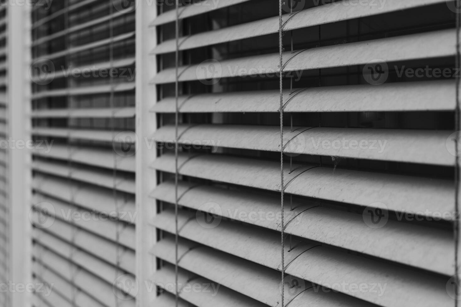 image is a close up of a window with white blinds photo
