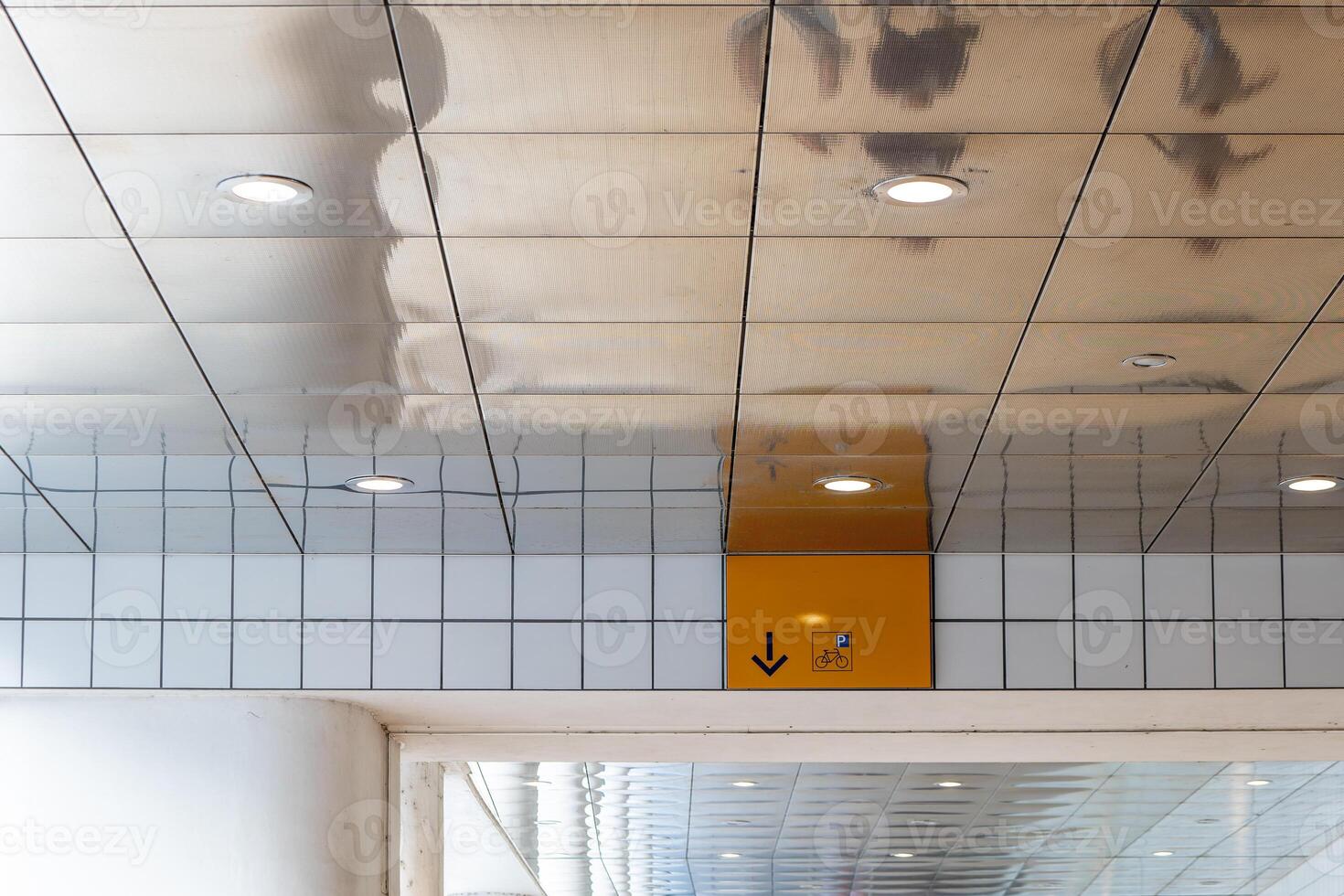 sign on a wall with a yellow arrow pointing up photo