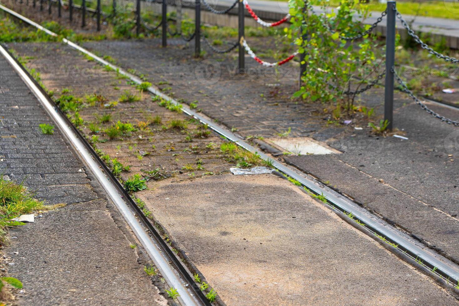train track with a fence and chain link fence photo