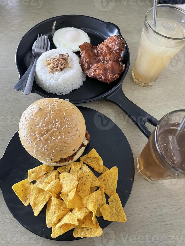 two portions of food, namely burgers and chicken cheese and rice. top view. photo