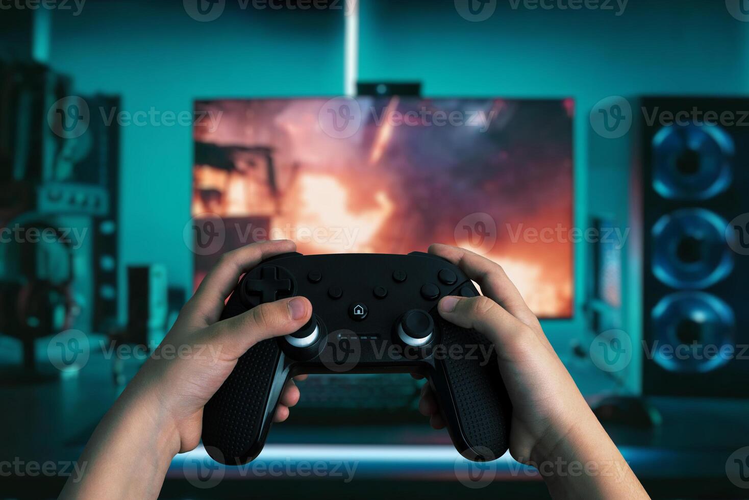 Dynamic image of hands holding a gamepad in front of a modern gaming computer, with vibrant LED lights, playing an action-packed game photo