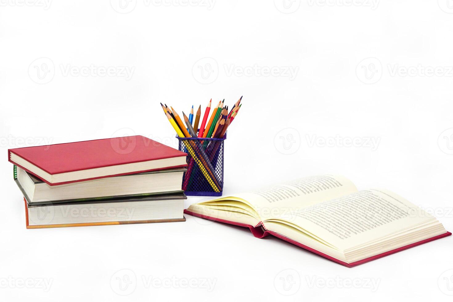 Crayon or colored pencils in box and the book placed in the blurred background. Knowledge and education concept. photo