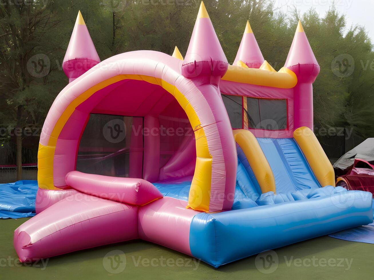 Inflatable colorful bounce house water slide in the backyard. photo