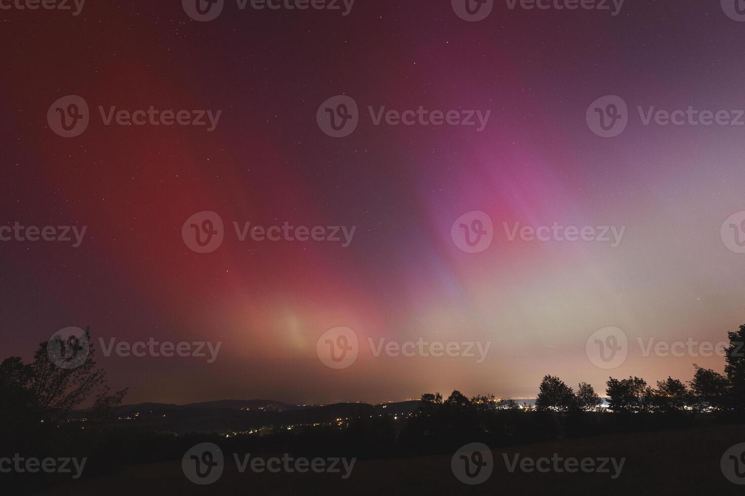Pink, yellow and red aurora dancing over the Czech Republic. A great solar storm. Night sky under a geomagnetic storm turning pink. A miracle in the Czech Republic. Northern lights photo