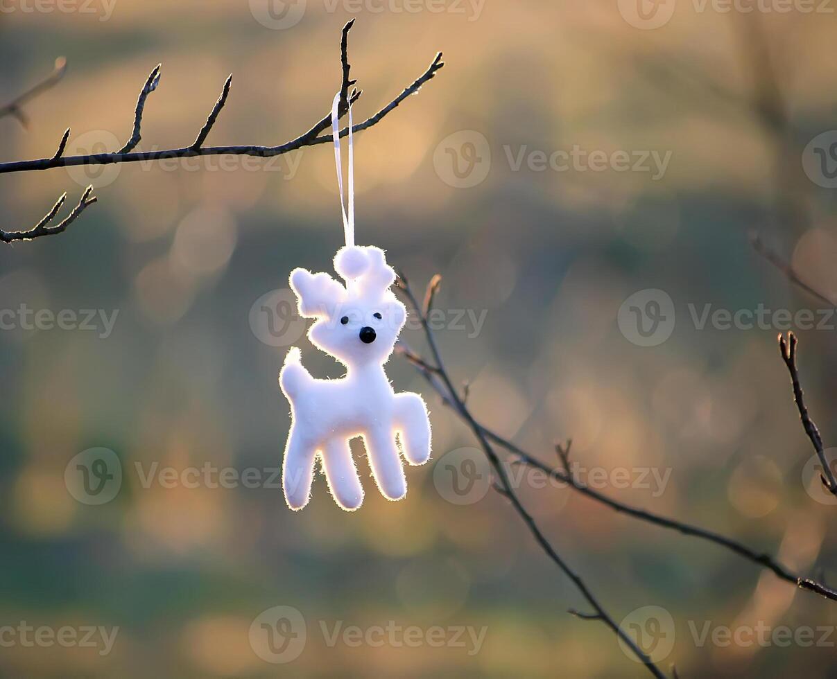 Christmas toy white deer hanging on tree branch outdoors photo