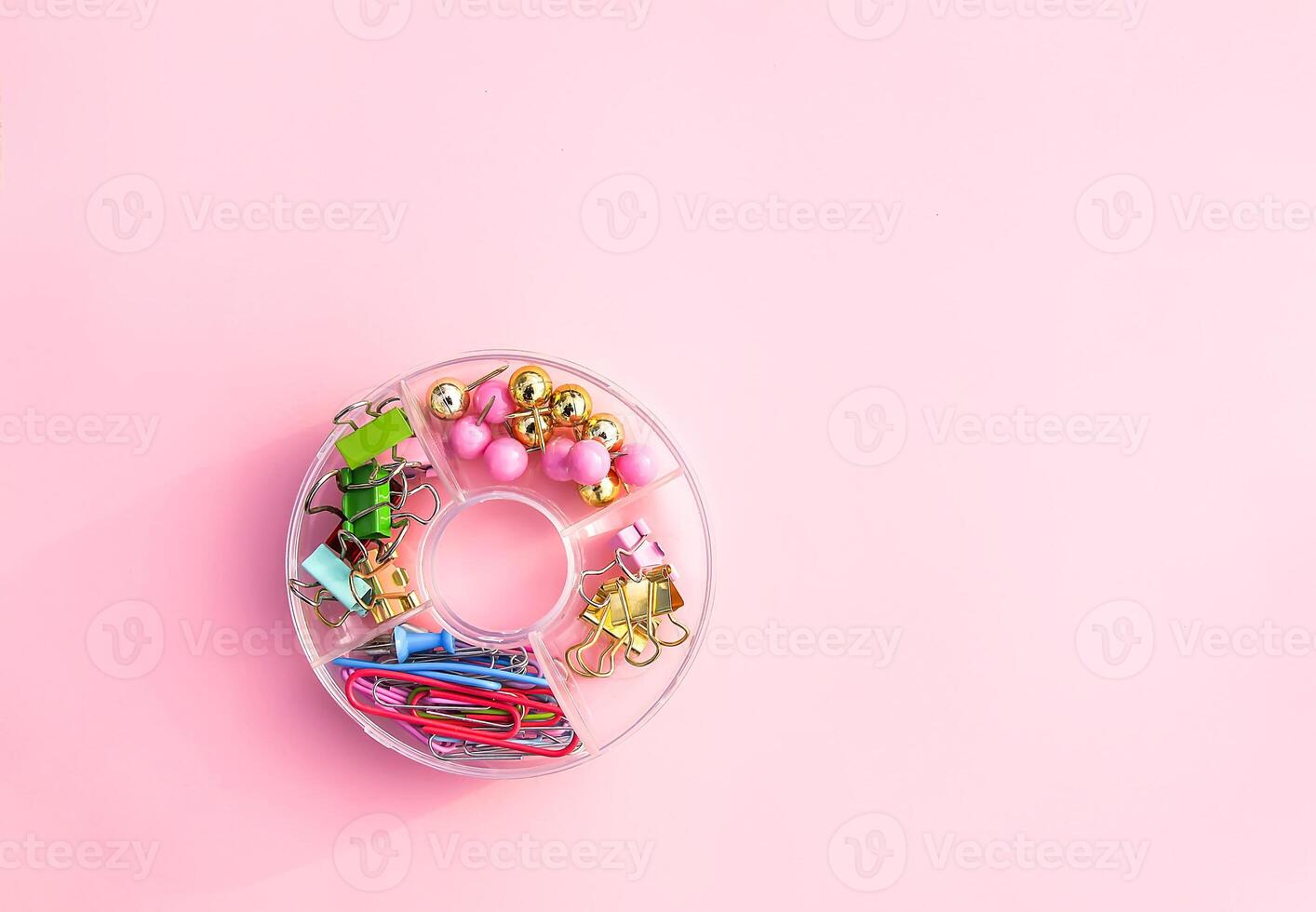 Bouquet of garden daisies with a red ribbon in a pot on a rough table. Blurred background. photo