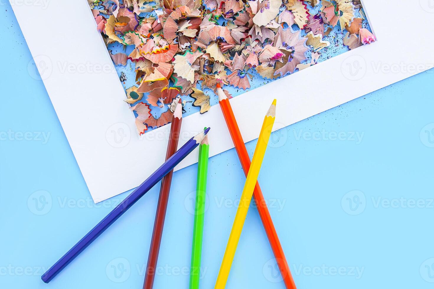 Wooden pencil shavings from sharpener and colored pencils photo