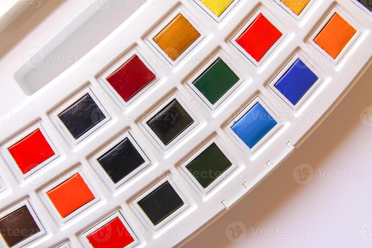 Watercolor paints on white background. Flat lay, top view photo