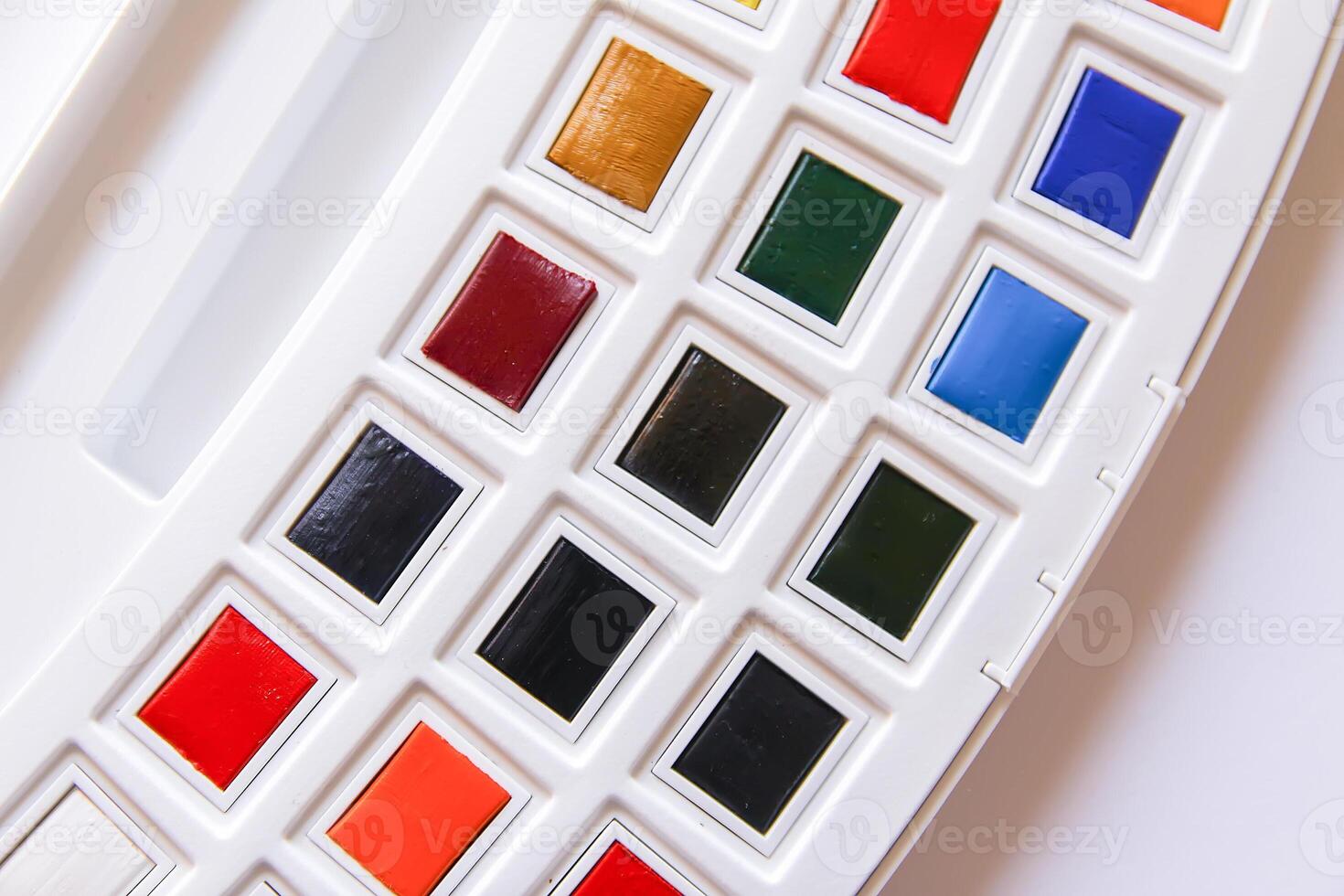 Watercolor paints on white background. Flat lay, top view photo
