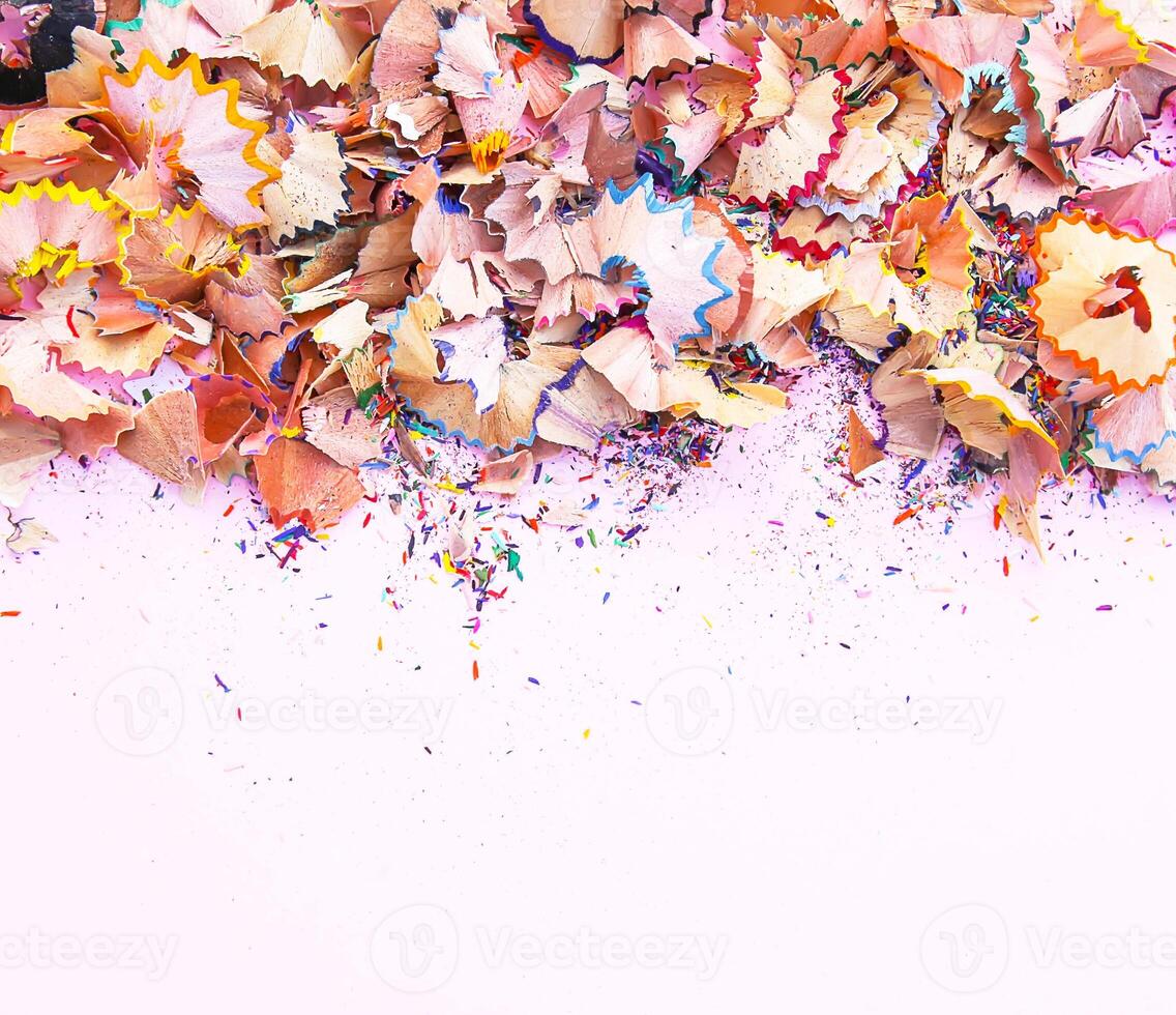 Wooden pencil shavings and colorful crumbs of graphite from sharpener. Top view. photo