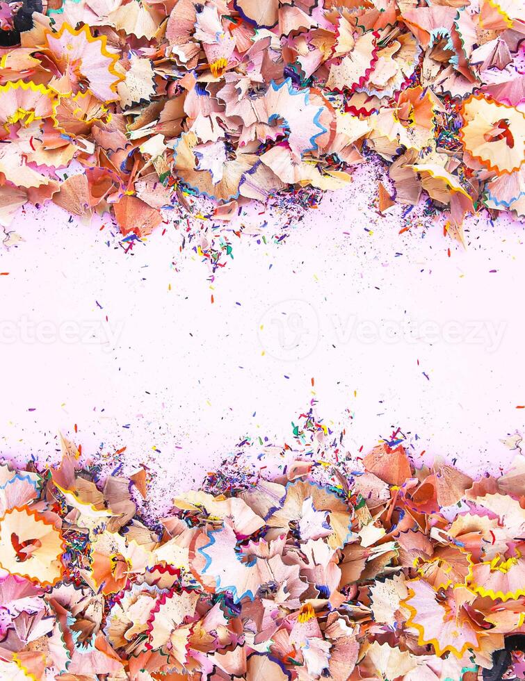 Wooden pencil shavings and colorful crumbs of graphite from sharpener. Top view. photo