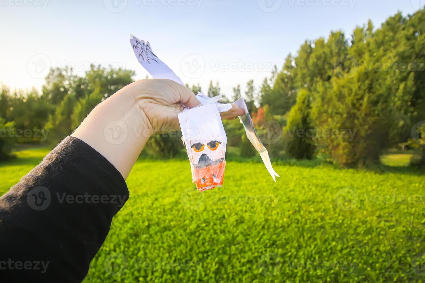 Hand holding paper origami bird photo