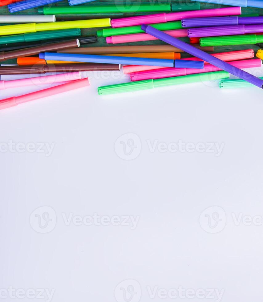 School supplies. Back to School design elements. Colorful markers and white empty paper sheet. photo