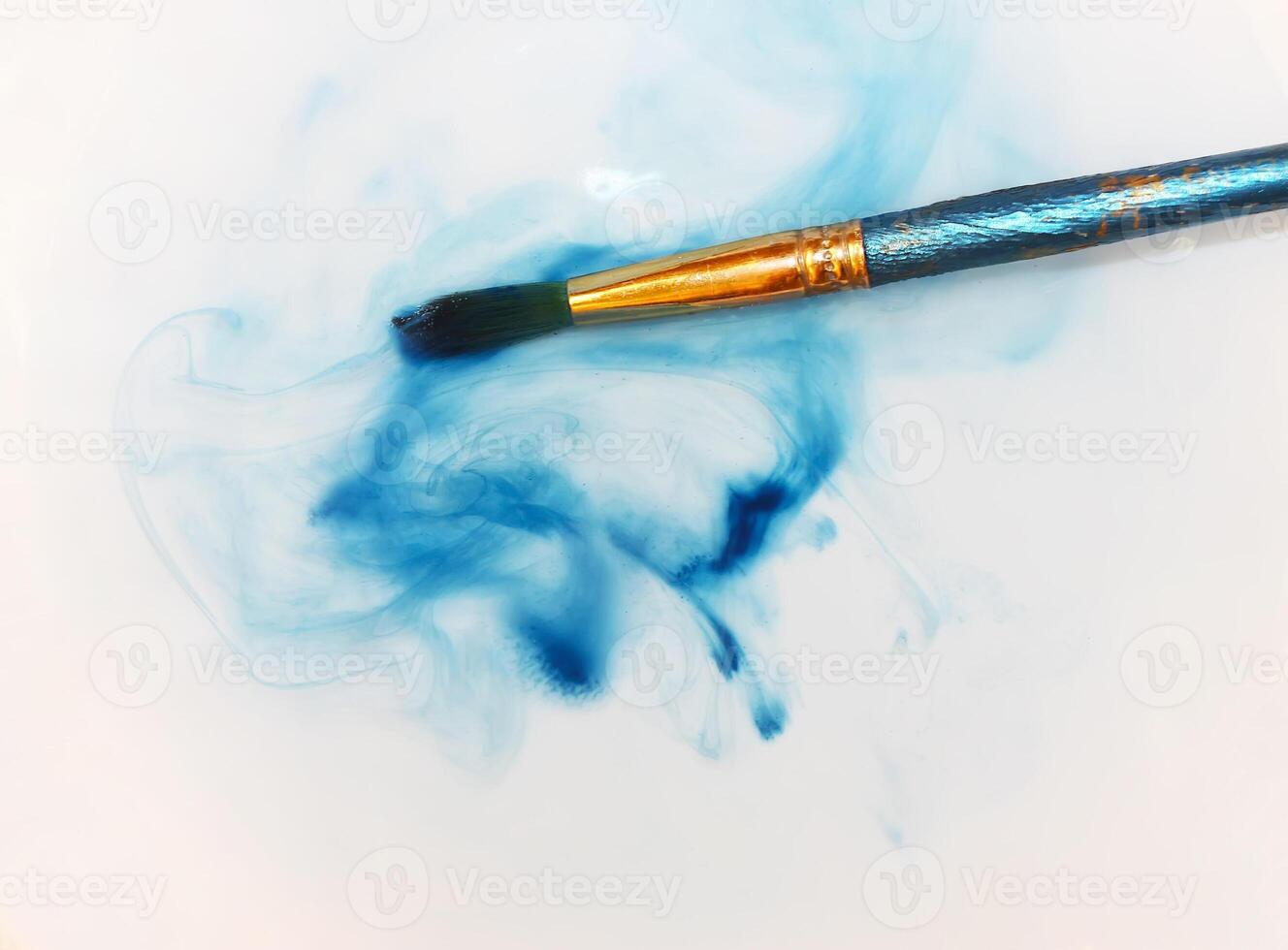 Brush closeup dip with watercolor paint photo