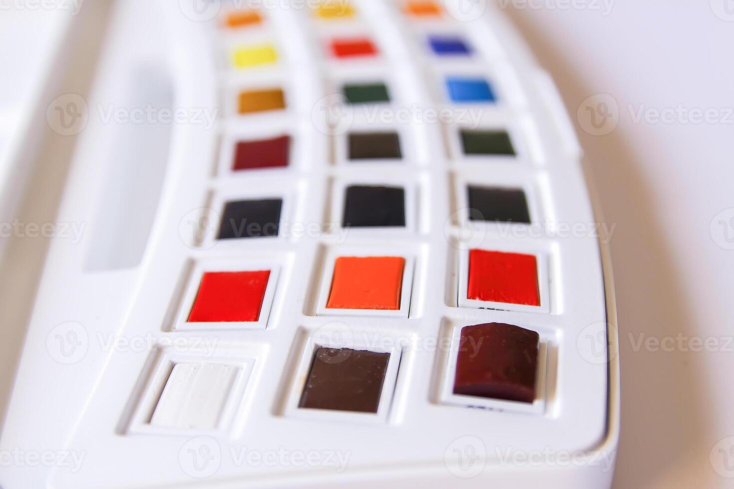 Watercolor paints on white background. Flat lay, top view photo