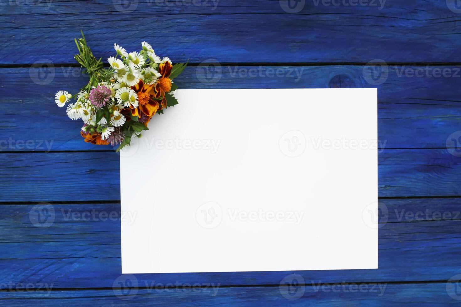 Summer flowers with blank paper for greeting message. Vintage Floral mock up with wild flowers. photo